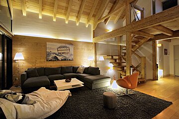 A living room with a couch and a painting on the wall that says ski