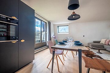 A kitchen with a clock that says 12:00 on it