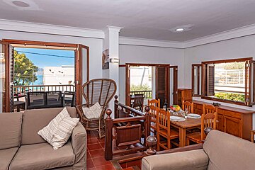 A living room with a couch a chair and a table