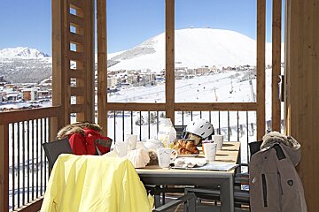 A view of a snowy mountain from a balcony