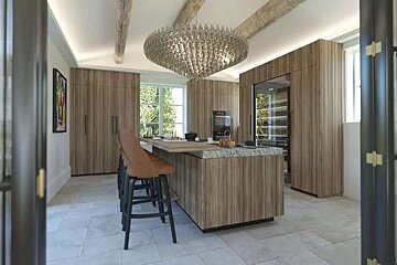 A kitchen with a large island and a chandelier hanging from the ceiling