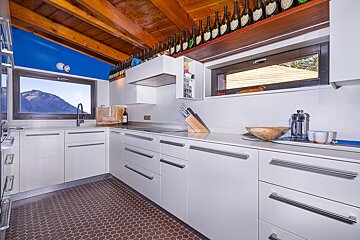 A kitchen with bottles of dom perignon on the ceiling