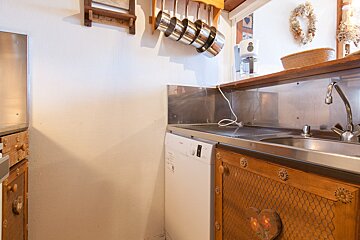 A kitchen with a stainless steel counter top and a bosch dishwasher