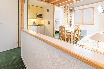 A room with a table and chairs and a microwave