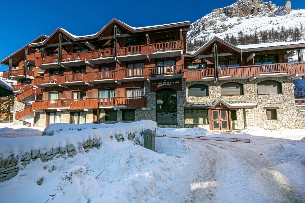 A large, rustic stone and wood ski chalet, 