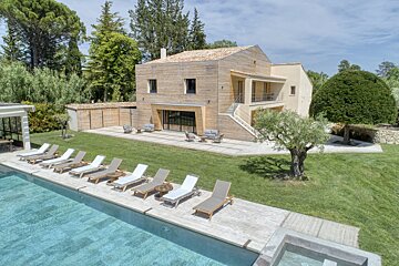 A large house with a swimming pool in front of it