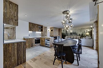 A kitchen with wooden cabinets and a dining table