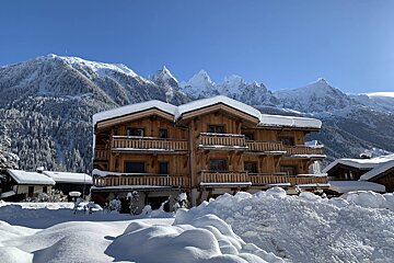 A large wooden house with a lot of balconies