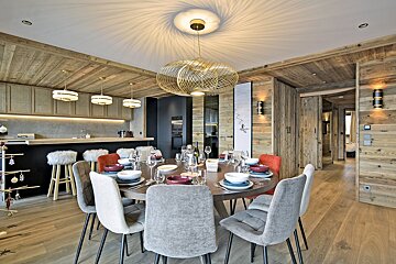 A dining room table with plates and bowls on it