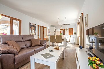 A living room with a brown couch and a white coffee table
