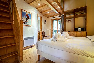 A bedroom with two beds and a poster on the wall that says chamonix