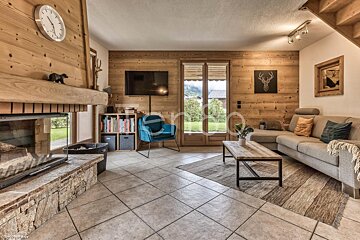 A living room with a fireplace and a clock on the wall