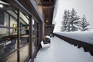A snowy balcony with a painting on the wall that says ' a ' on it