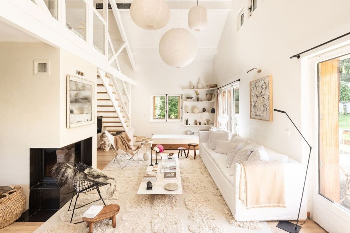A living room with a white couch and a fireplace