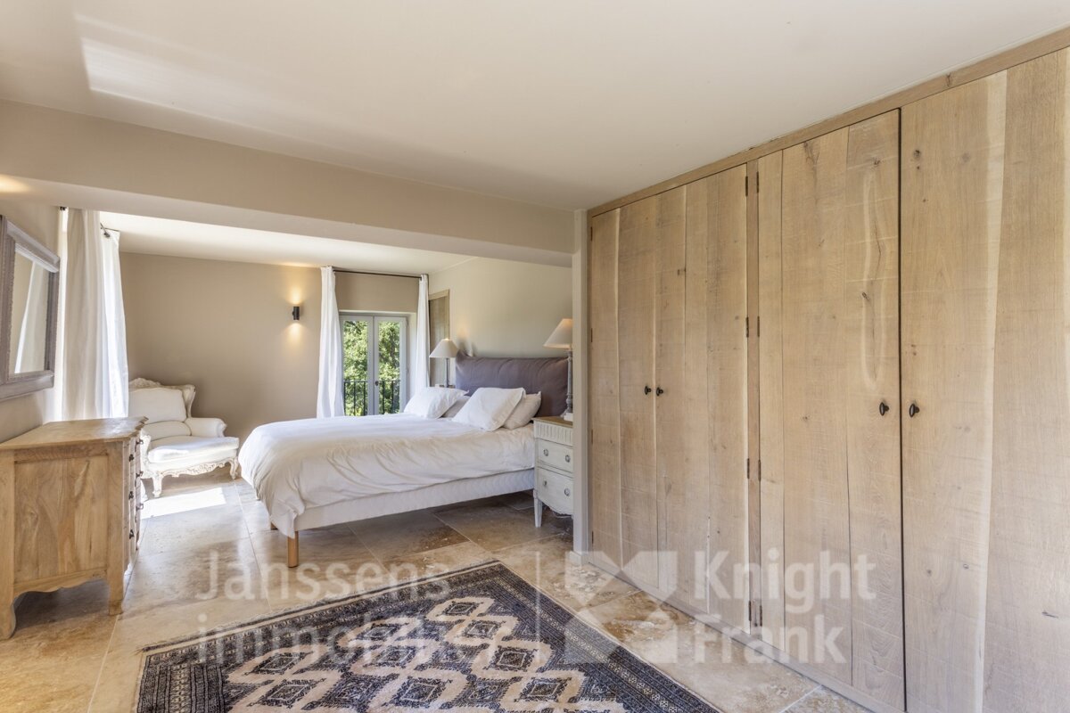 A bedroom with a bed and a rug that says knight frank