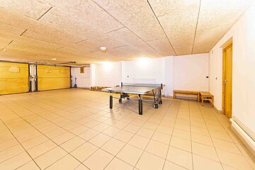A ping pong table in an empty garage