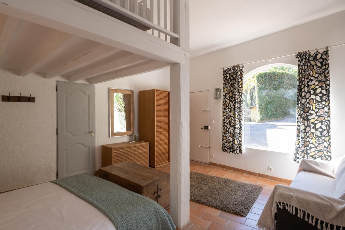 A bedroom with a bed and a couch in it