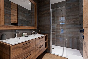 A bedroom with a rental designer logo on the corner