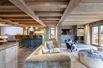 A living room with a couch and chairs and a fireplace