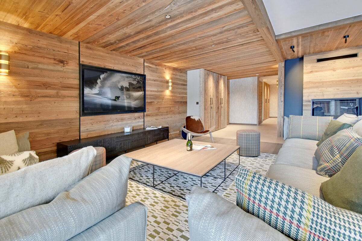 A living room with a large flat screen tv on the wall