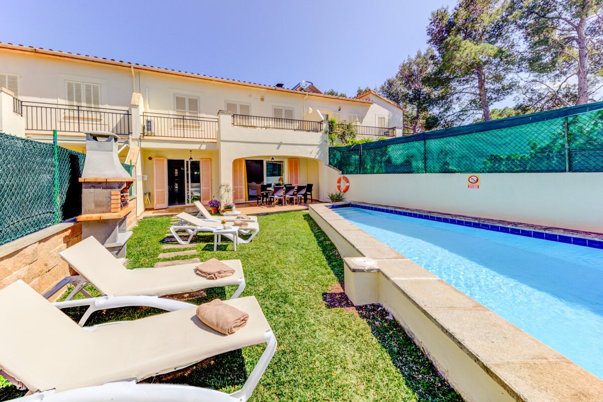A house with a swimming pool in front of it