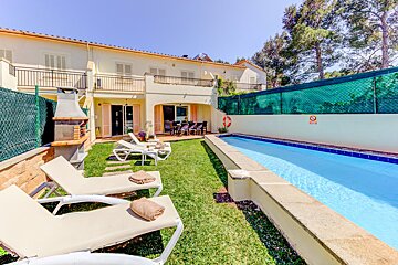 A house with a swimming pool in front of it