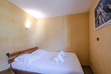 A small bedroom with a poster on the wall that says