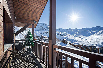 A balcony with a view of snow covered mountains