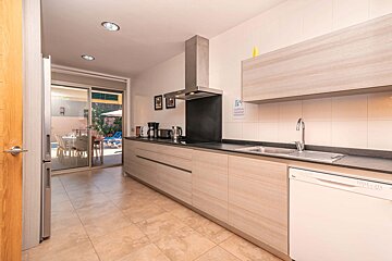 A kitchen with a sign on the wall that says