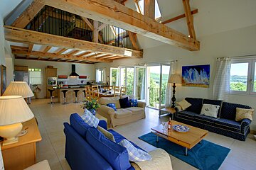 A living room with a blue couch and a white couch