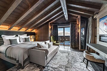 A bedroom with a large bed and a couch