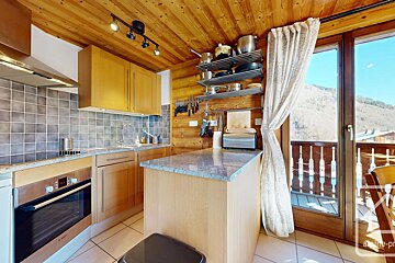 A kitchen with a bosch oven and a trash can