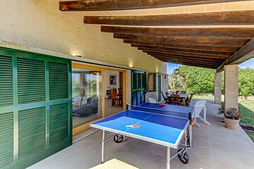 A blue and white ping pong table on a patio