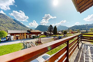 A balcony with a view of mountains and a sign that says alpine pro