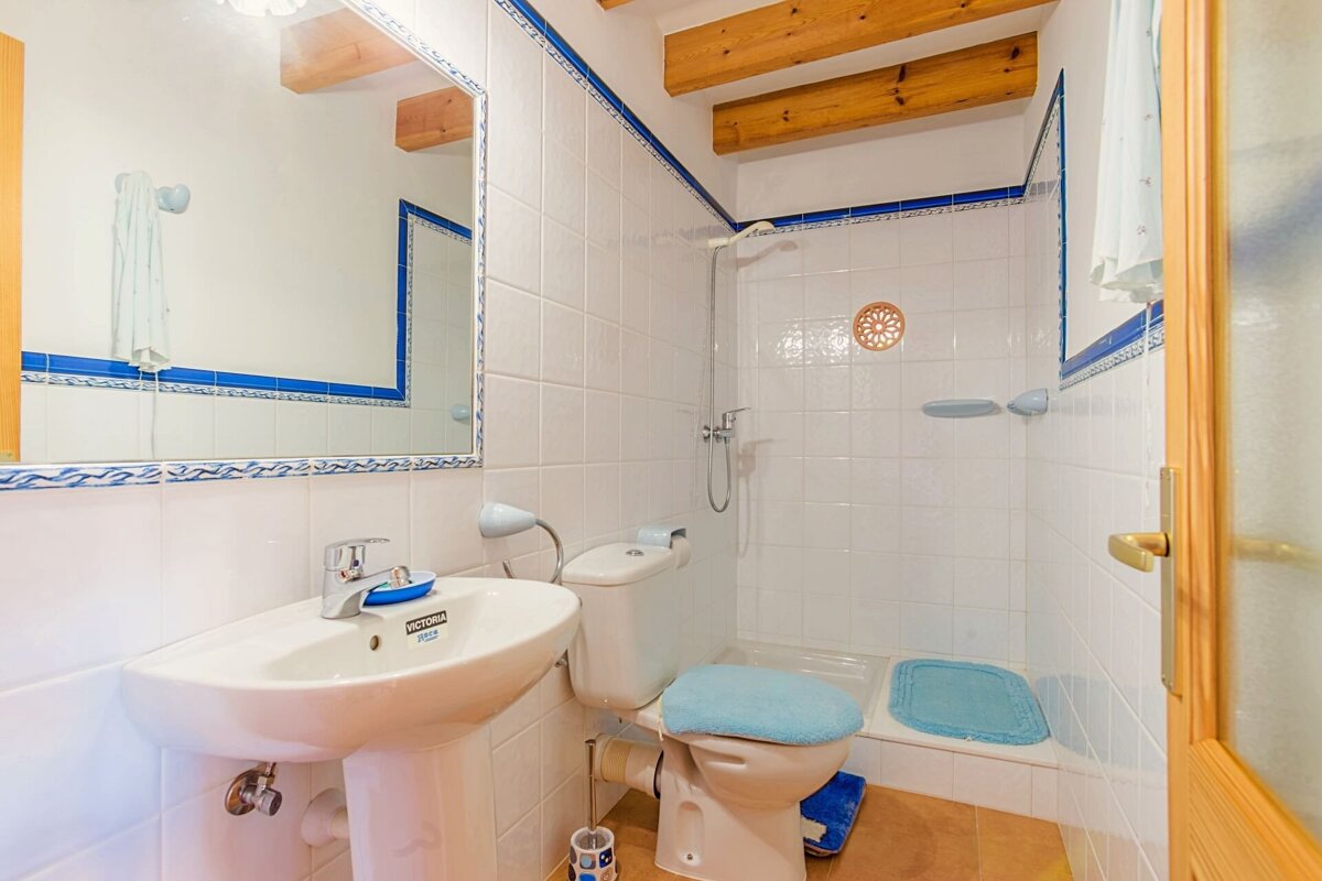 A bathroom with a sink and toilet with a soap dish that says ' johnson ' on it
