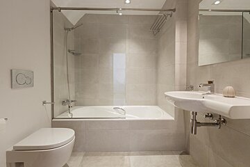 A bathroom with a toilet a sink and a shower