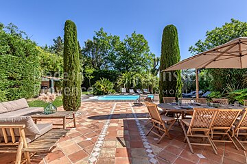 A patio with a table and chairs and an umbrella that says provence