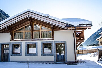 A white house with snow on the roof