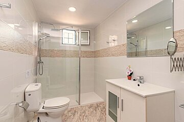 A bathroom with a toilet a sink and a mirror