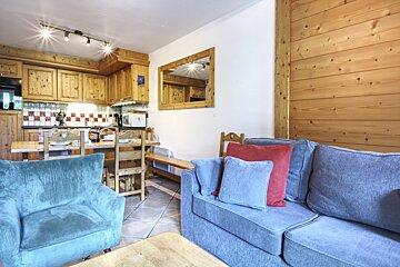 A living room with a couch and two chairs