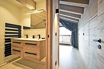A bathroom with two sinks and a towel rack