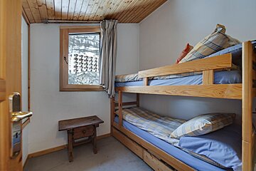 A bedroom with two bunk beds and a window