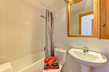A bathroom with a sink toilet and bathtub