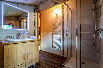 A bathroom with a sink and a shower with the word terro on the wall