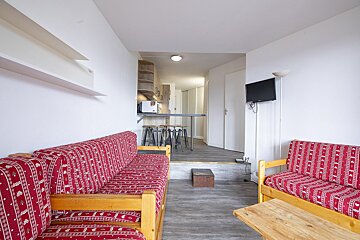 A living room with a couch and two chairs