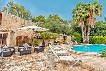 A swimming pool surrounded by chairs and a white umbrella