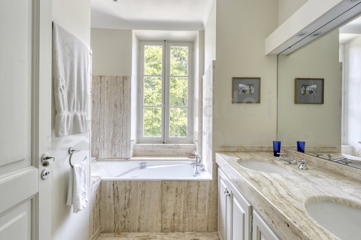 A bathroom with two sinks and a window