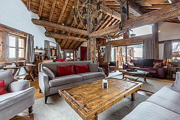 A living room filled with furniture and a wooden table