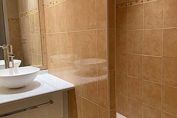 A bathroom with two sinks and a mirror