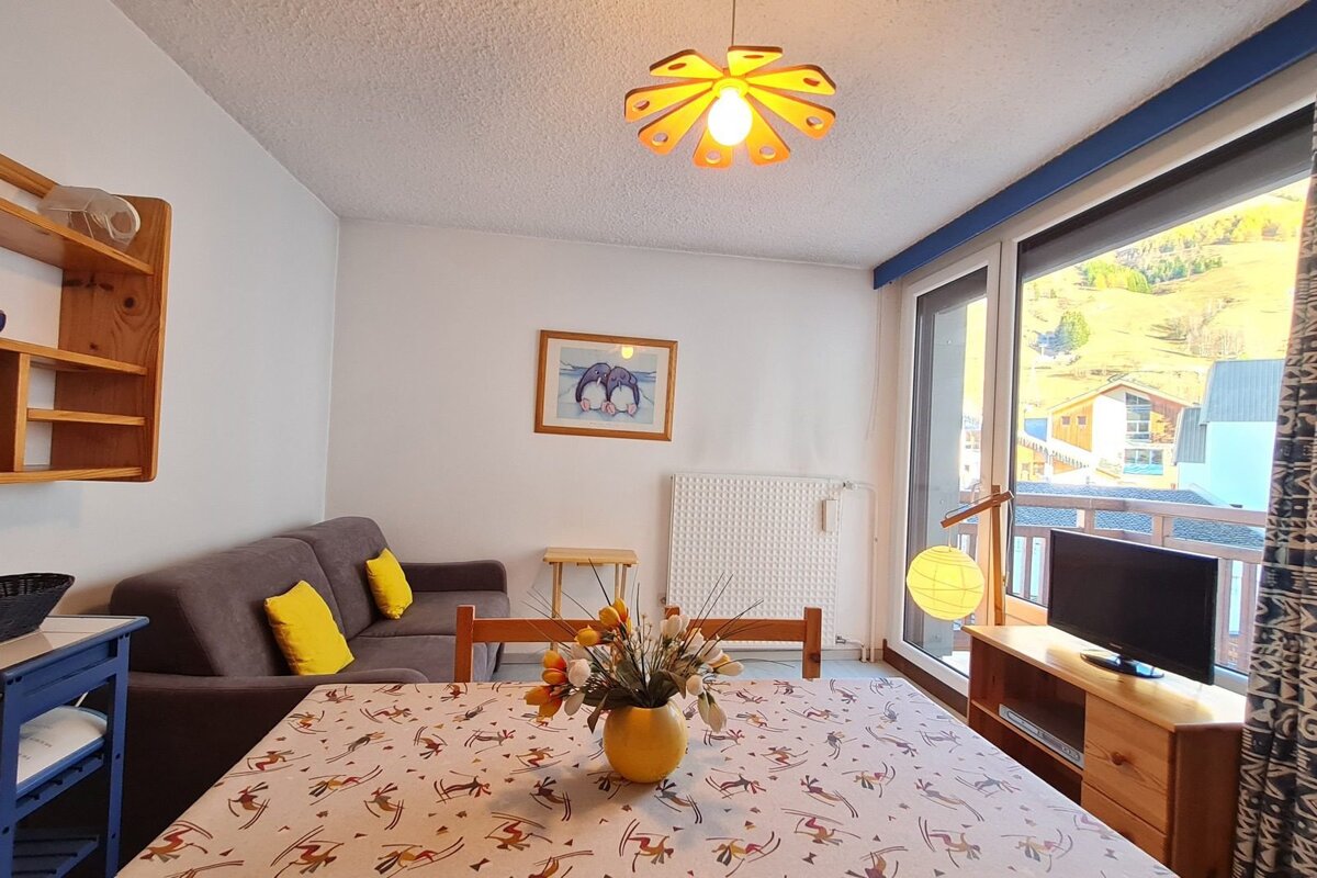 A living room with a couch a table and a television